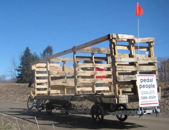 Pedal People moving newly-constructed recycling bins on two bicycle trailers.jpg