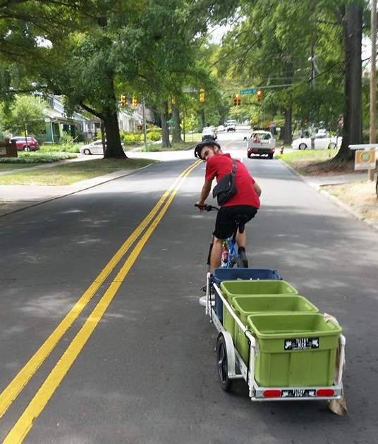 Tilthy Rich rider and trailer on a residential street